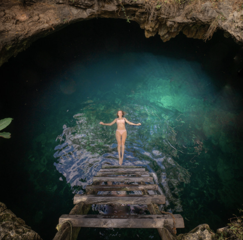 Person swimming in a natural pool.